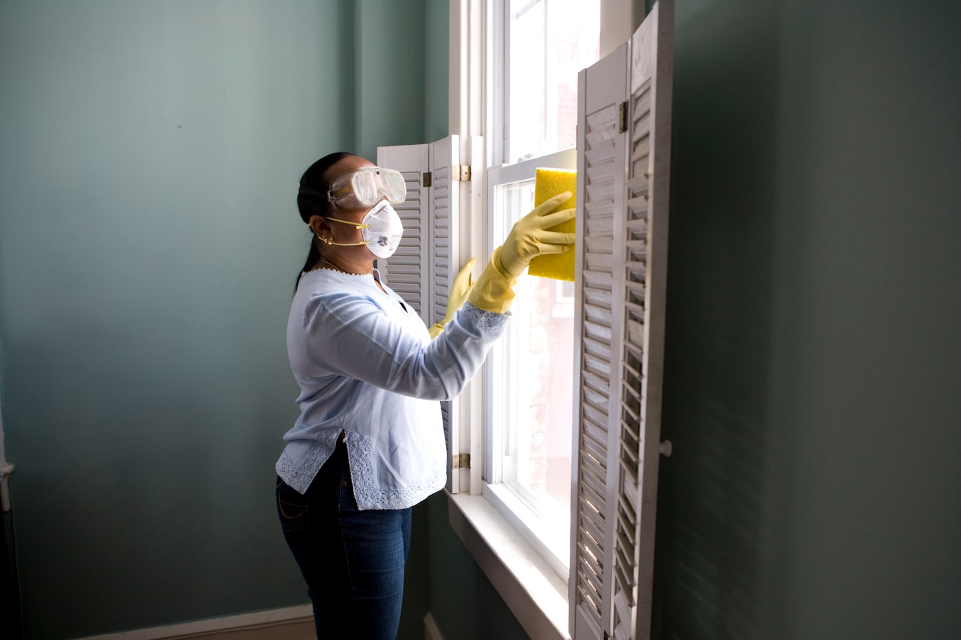 Professional carefully cleaning a window